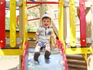young boy on a slide