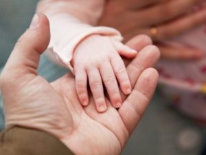 parent holding child's hand