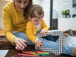 mother sitting with child playing